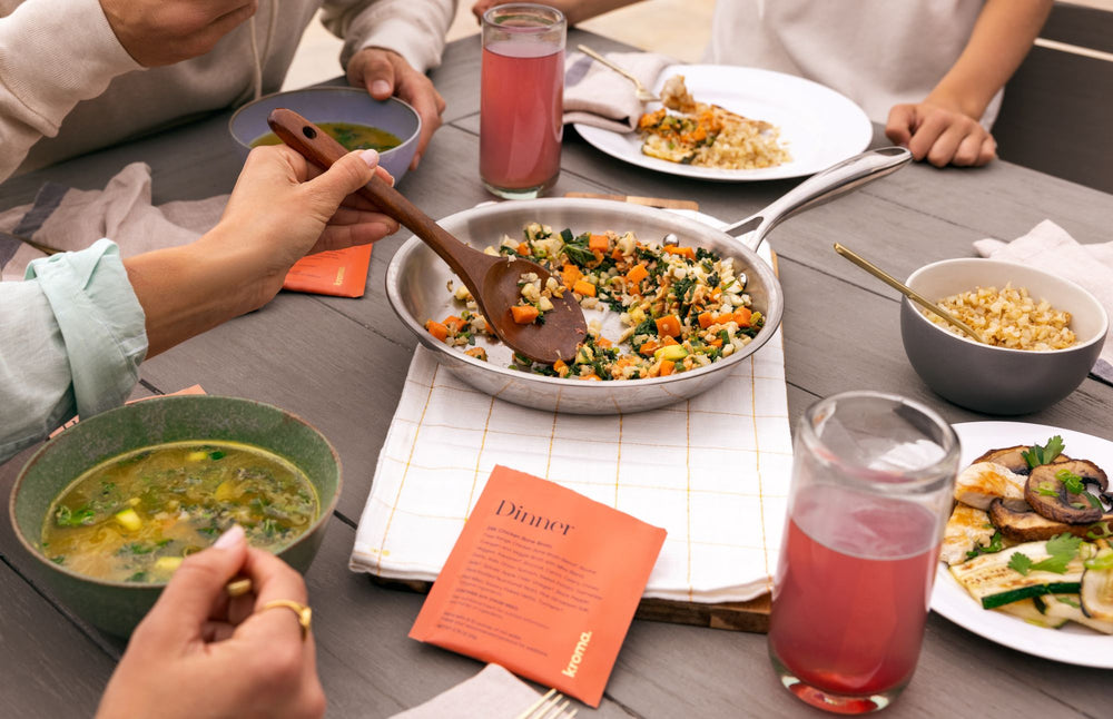 People enjoying a meal together at a table with various dishes and drinks.