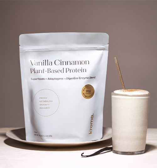 Vanilla Cinnamon Plant-Based Protein package with a glass of protein shake on a neutral background