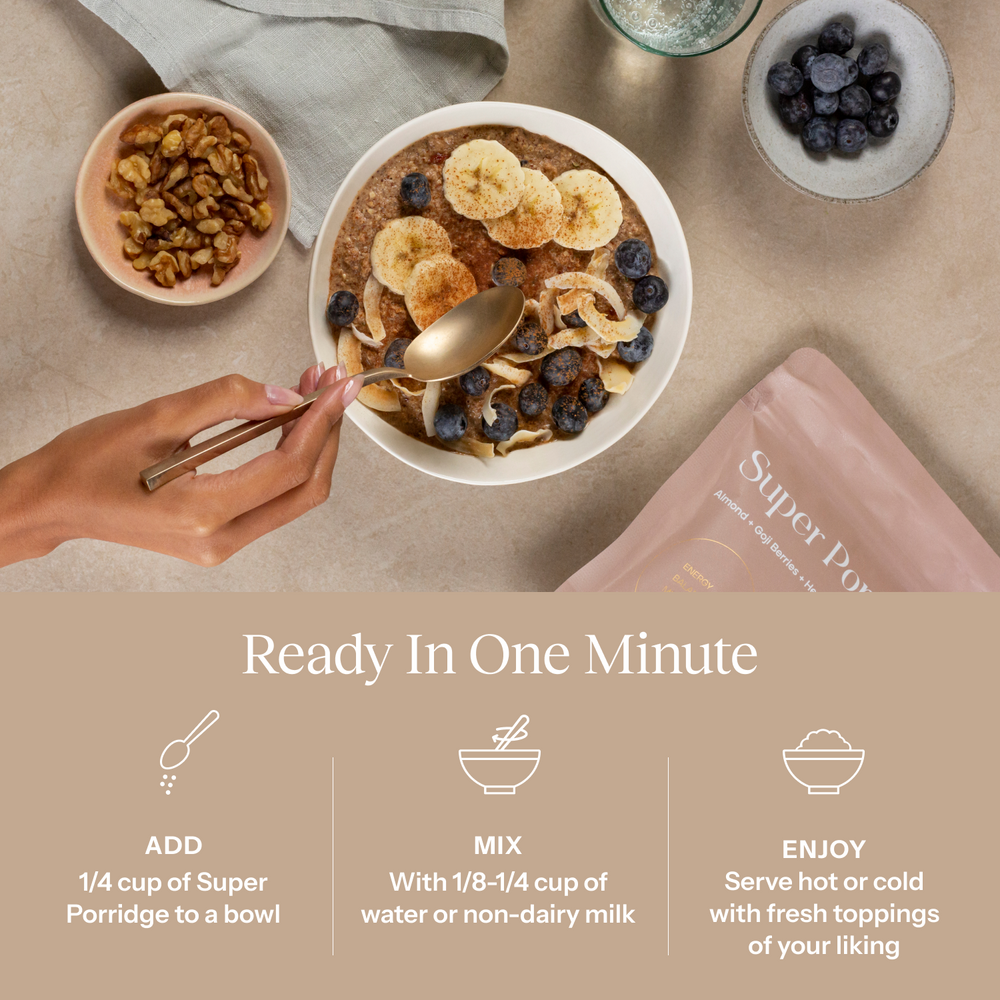 Cereal bowl with toppings, hand holding a spoon, and Super Porridge packaging on a table.